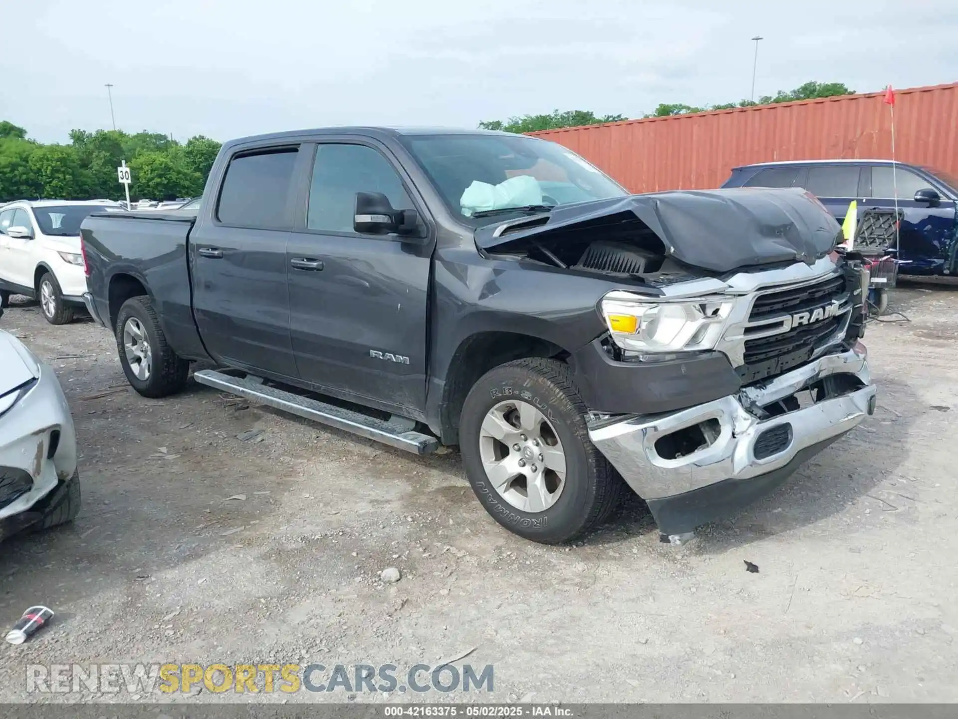 1 Photograph of a damaged car 1C6SRFMT0MN672355 RAM 1500 2021