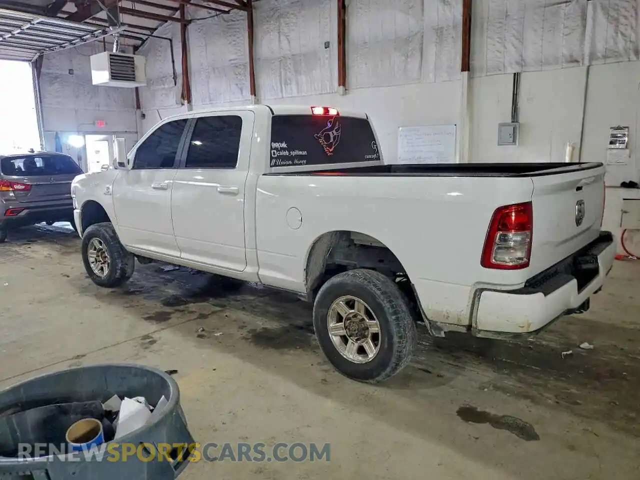 2 Photograph of a damaged car 3C6UR5DL7MG679539 RAM 2500 2021